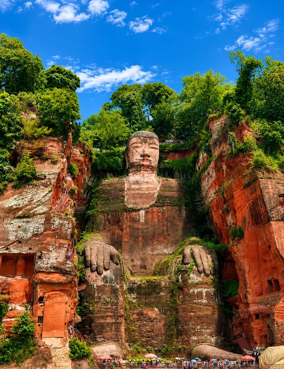 The 71-metre Leshan Giant Buddha carved into a red sandstone cliff above the confluence of three rivers in Sichuan