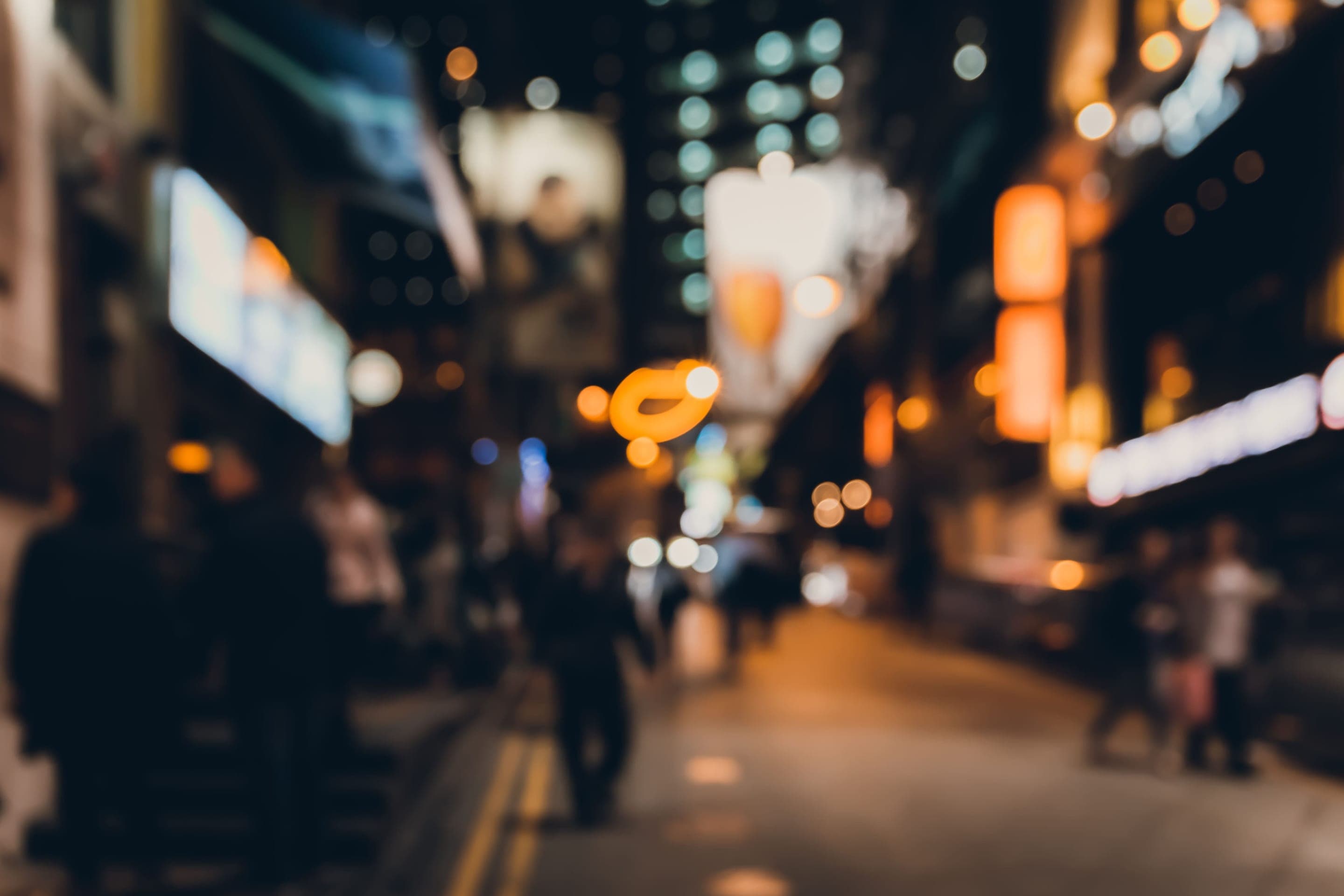 Soft-focus night view of a lantern-lit Chinese city street