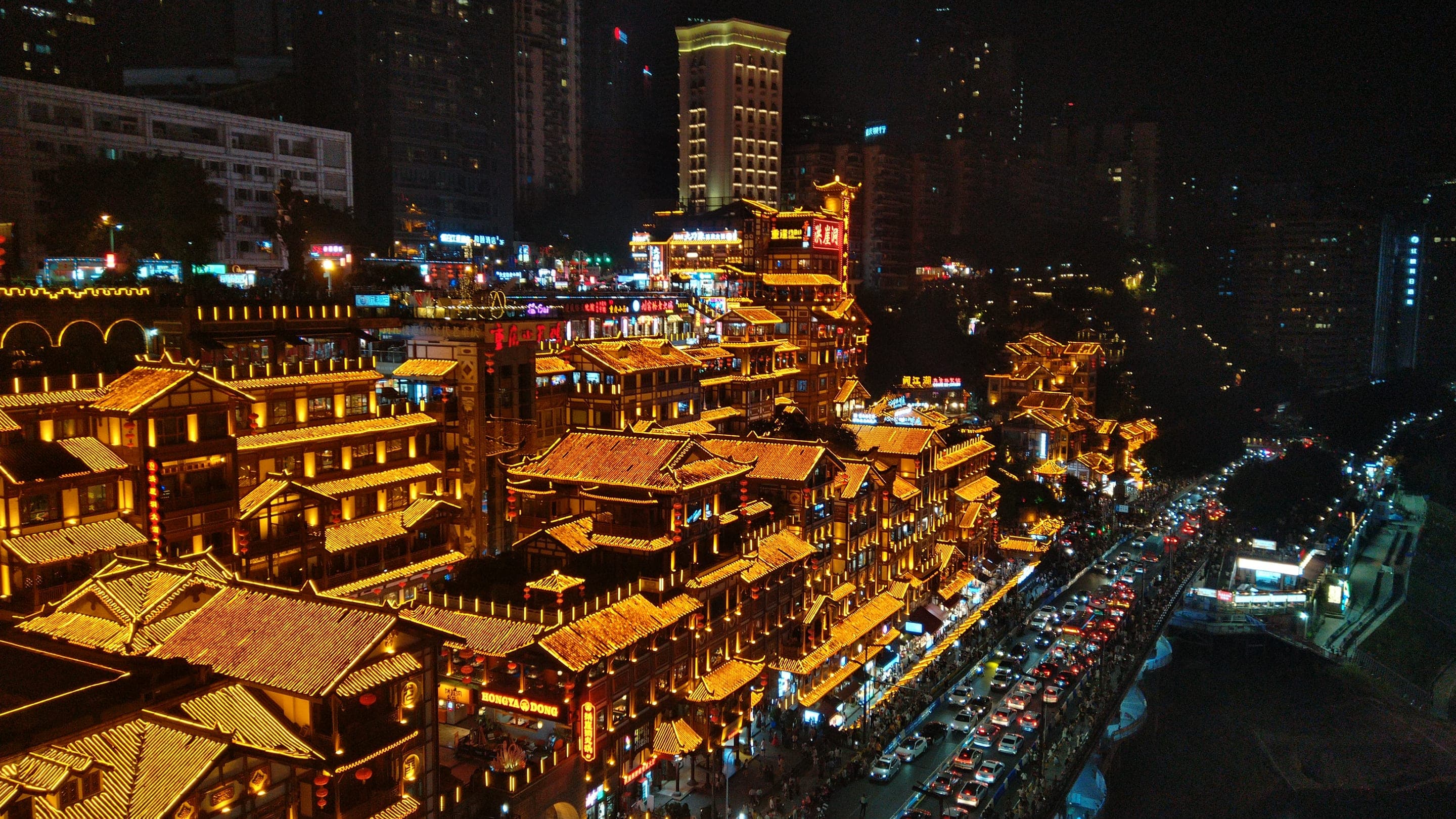 Hongya Cave's stilted houses lit up at night above the Jialing River, Chongqing