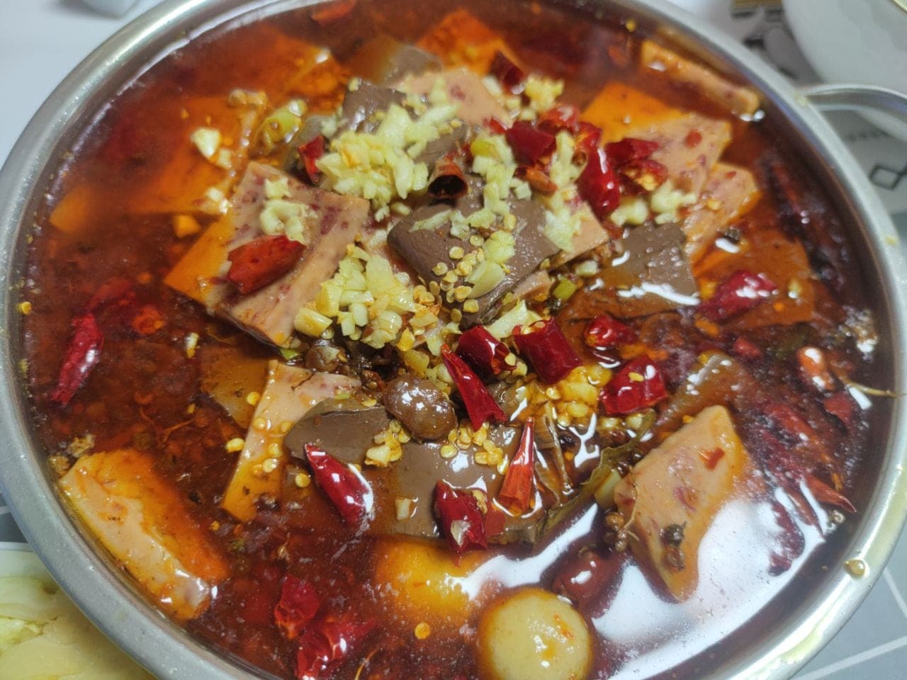 A Chongqing mao xue wang, duck blood and beef offal in a chilli-bean broth, served at a jianghu-cai house