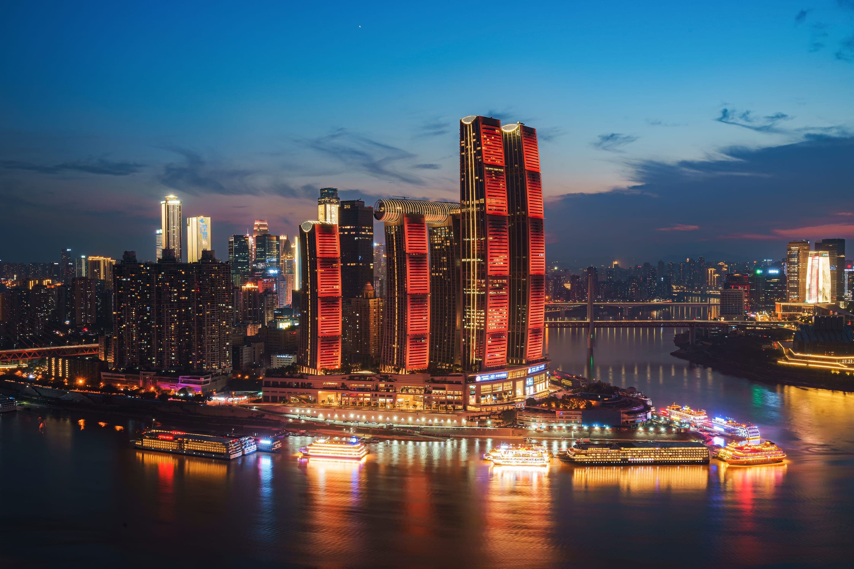 Raffles Chongqing at the tip of Chaotianmen, the Crystal sky bridge threaded between four towers above the meeting of the Yangtze and Jialing rivers