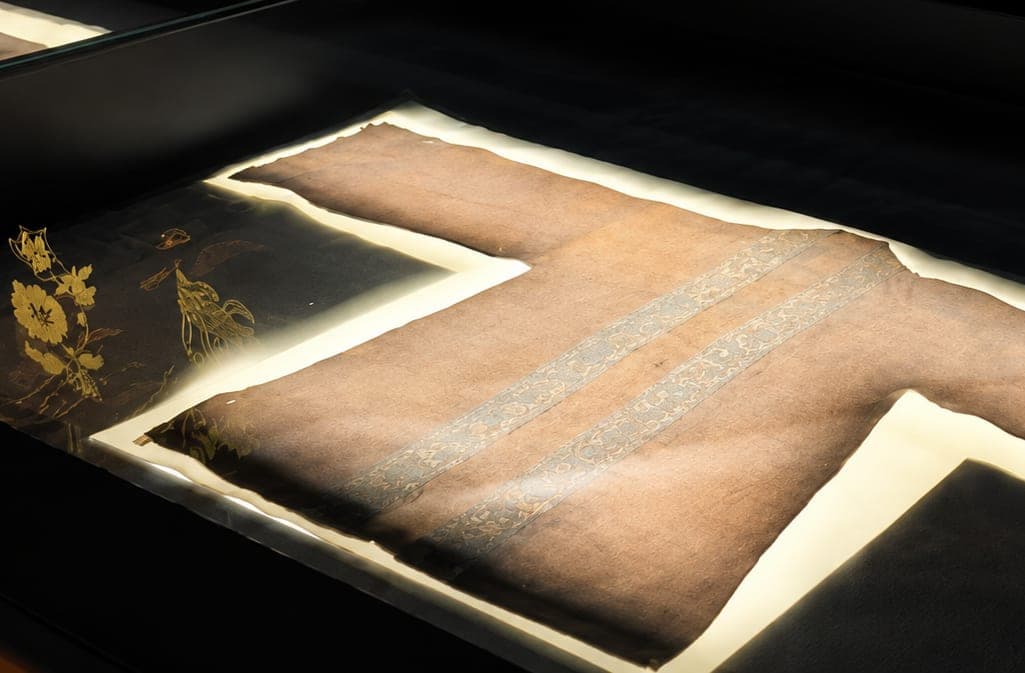 A historical silk garment laid out in a display case at the Fujian Museum, Fuzhou