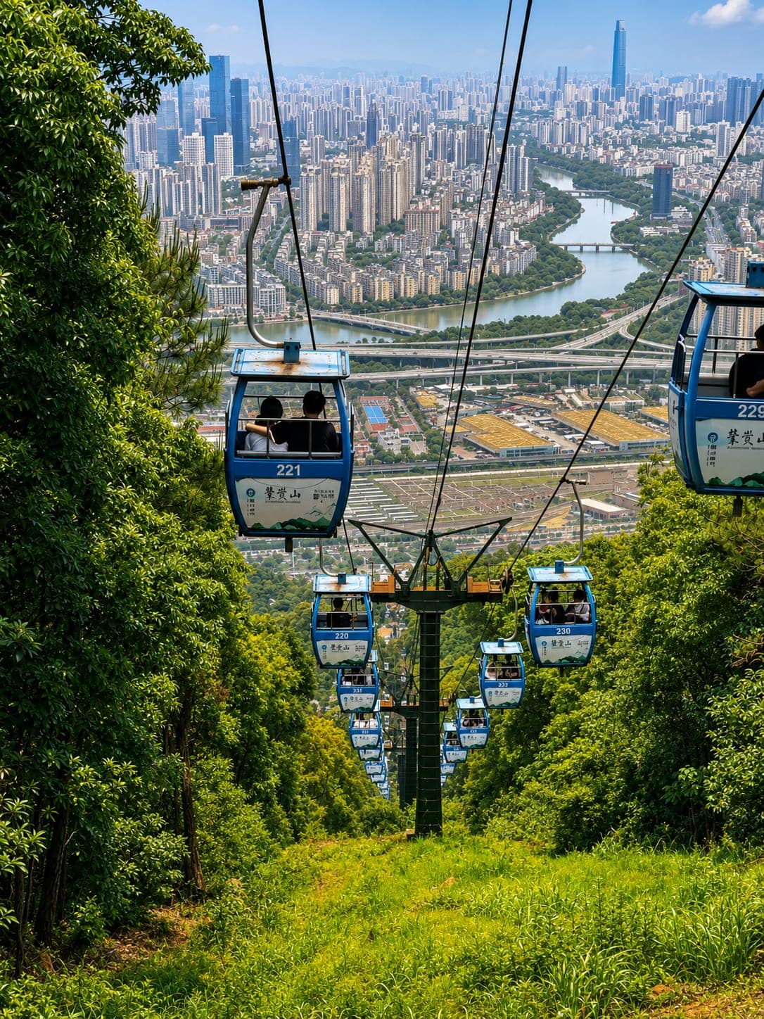 Cable cars descending Mount Gu toward central Fuzhou, with the Min River curving through the city below