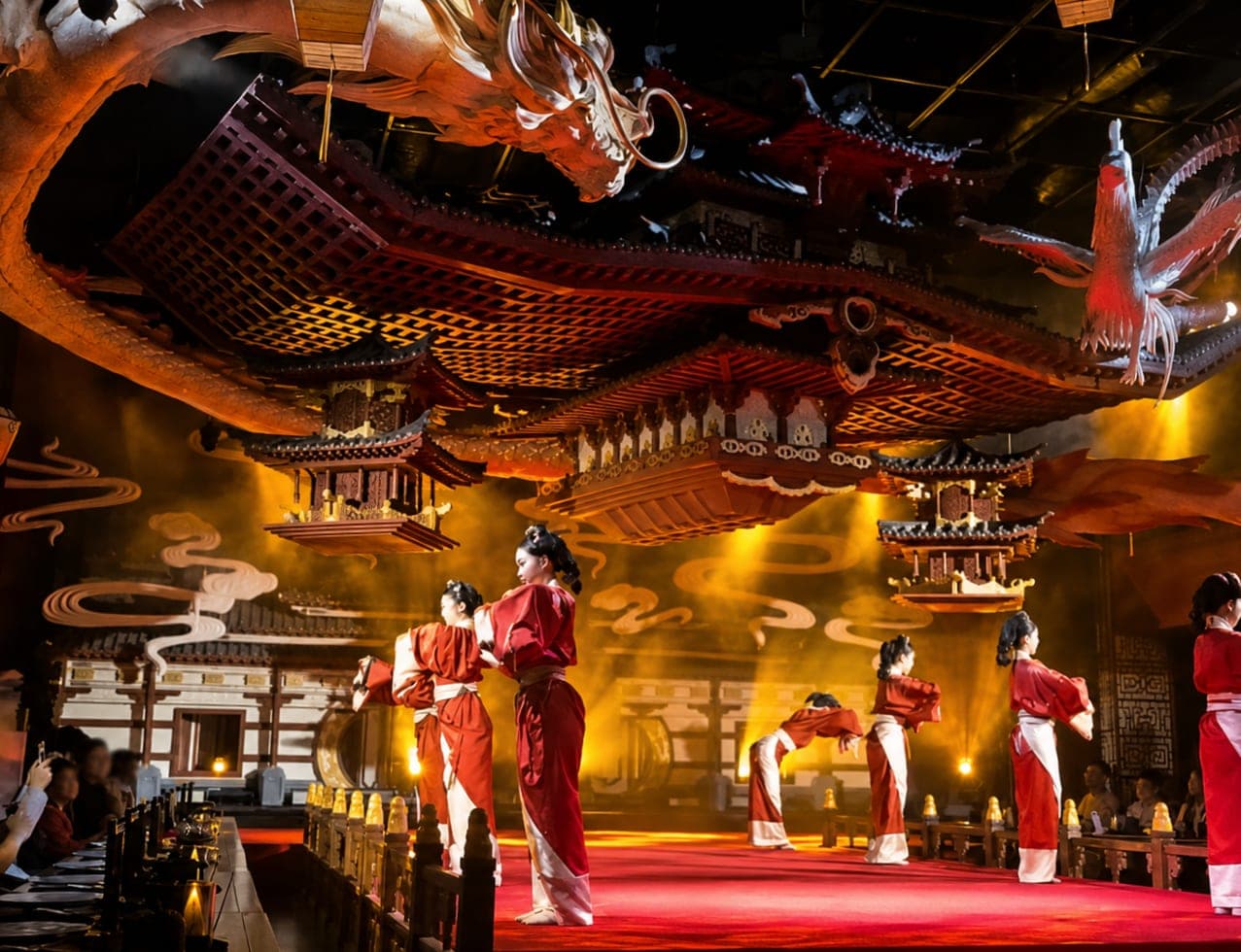 Dancers in red robes on a Cantonese banquet stage under an ornate Chinese-revival roof, Yueyan, Guangzhou