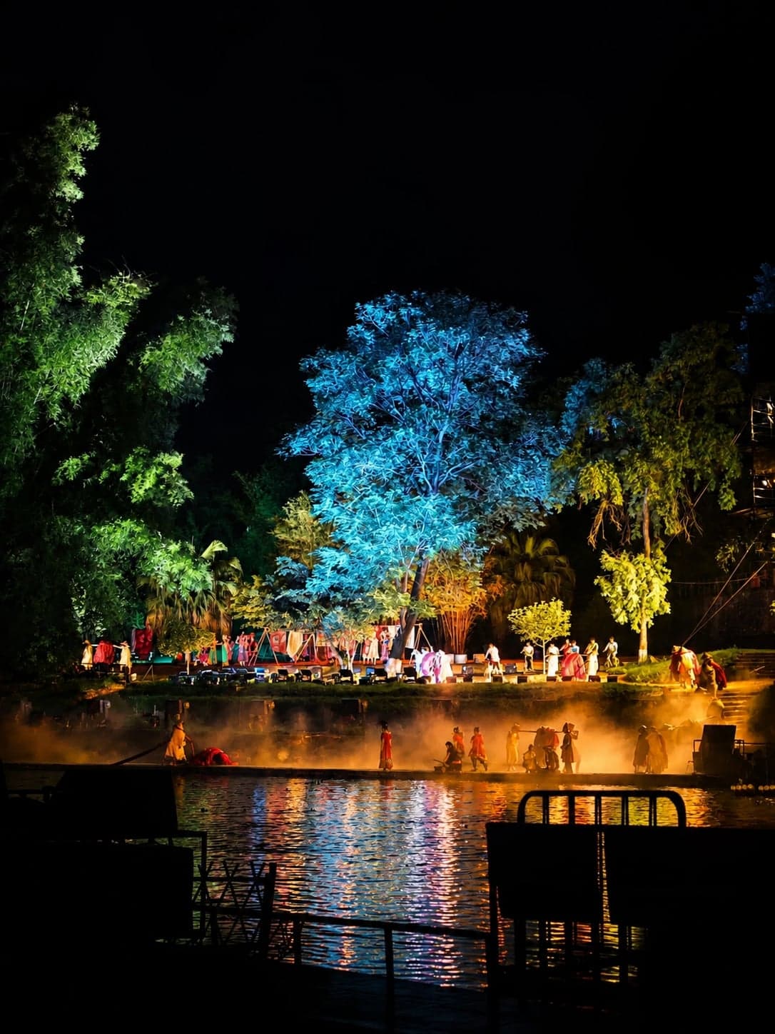 Hundreds of performers in conical hats and yellow tunics work the red fabric stage spread across the Li River at the Impression Liu Sanjie evening show