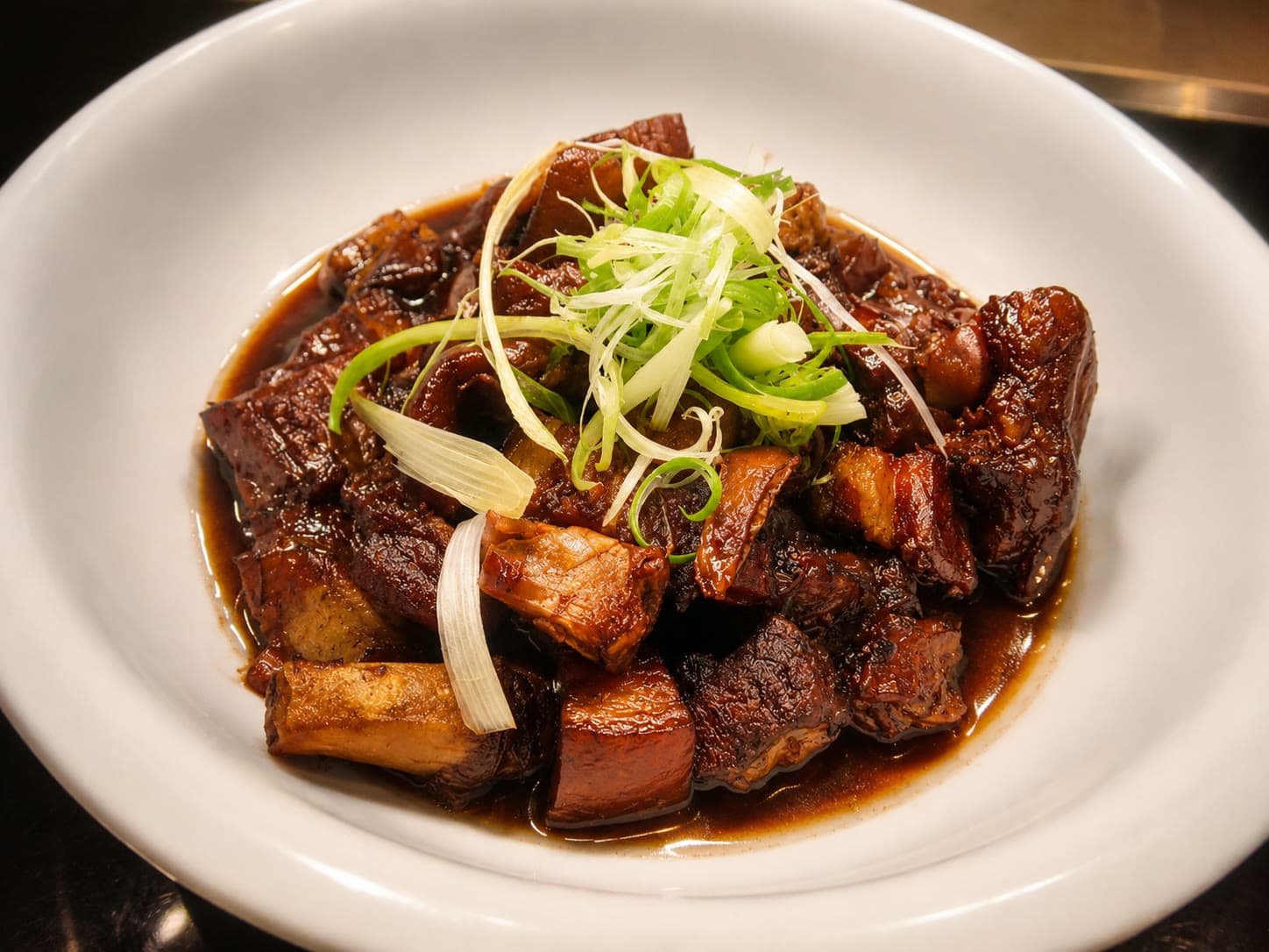 Dongpo pork: hand-cut pork belly braised in Shaoxing wine and rock sugar to a dark glaze, Hangzhou
