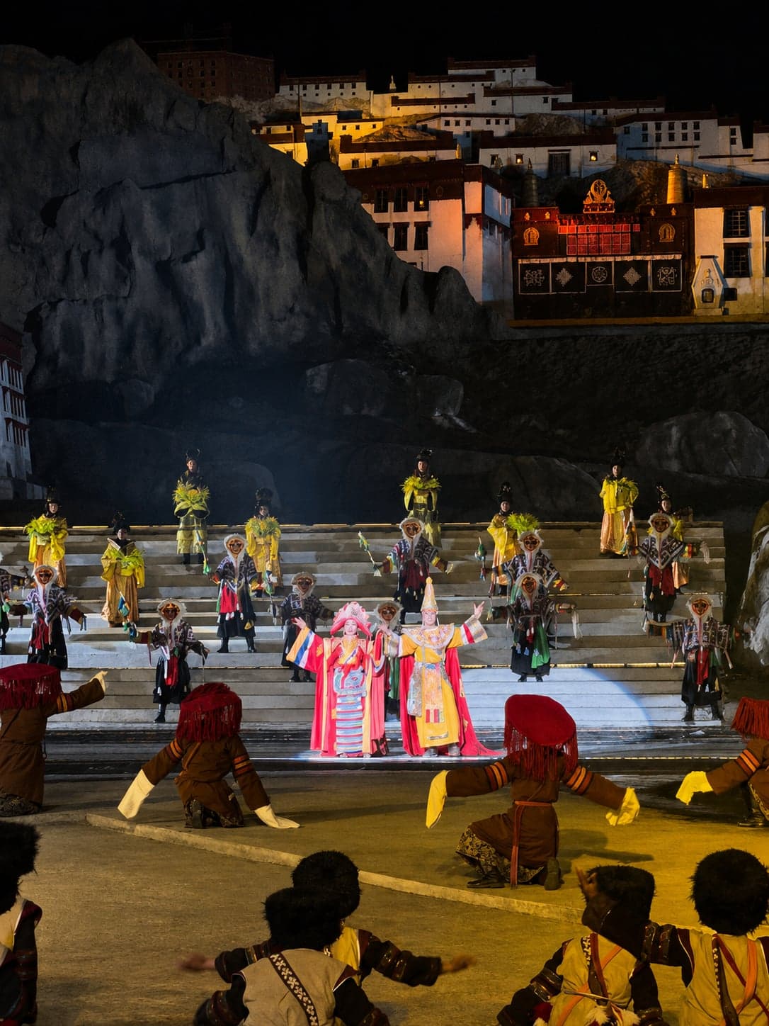 A chariot scene from the Princess Wencheng outdoor epic in Lhasa, the southern mountain range lit blue behind the stage
