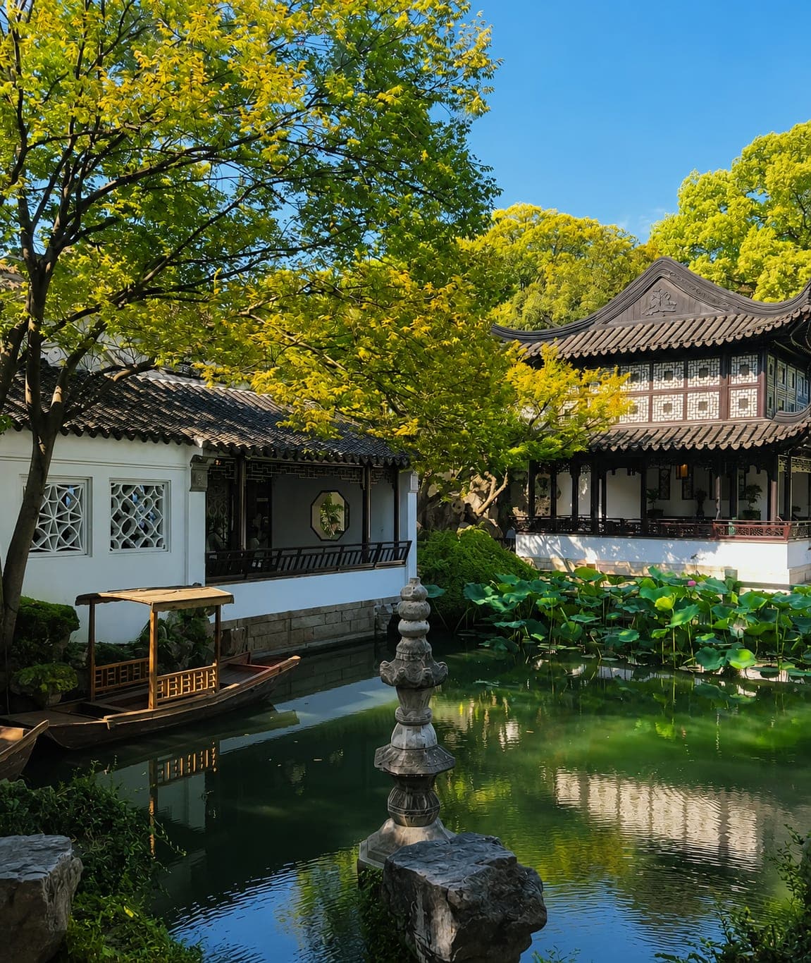 A pavilion and tiled hall around the lotus pond at Lingering Garden, one of China's four most famous classical gardens, Suzhou