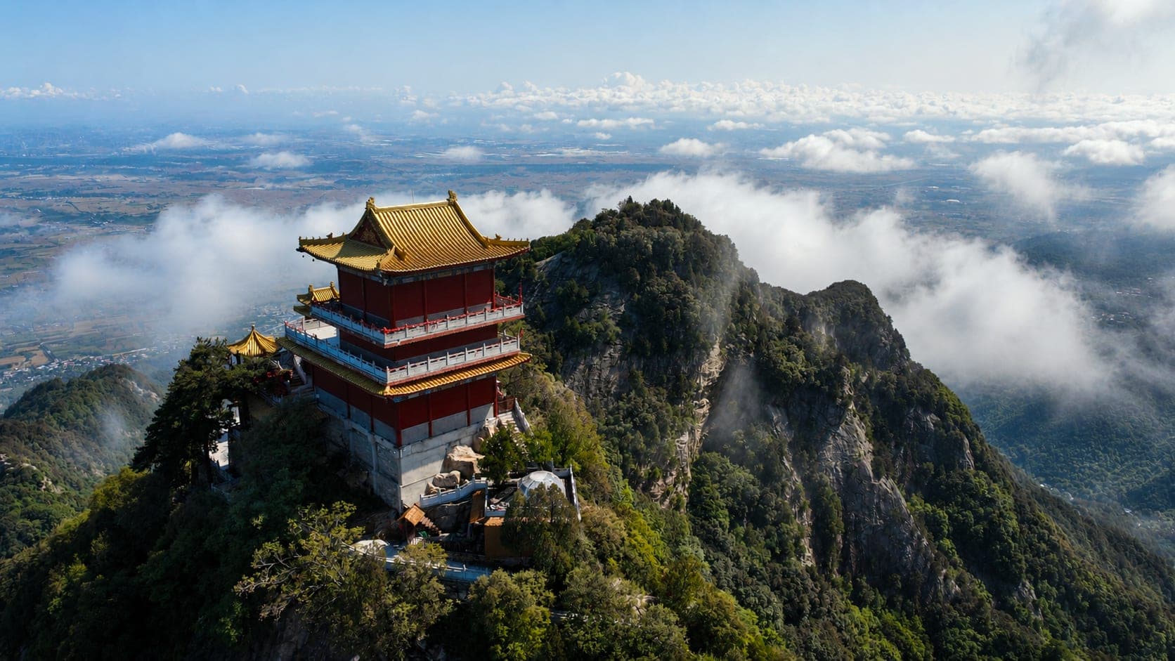 A ridge pavilion above the Qinling range, cloud drifting below the peaks