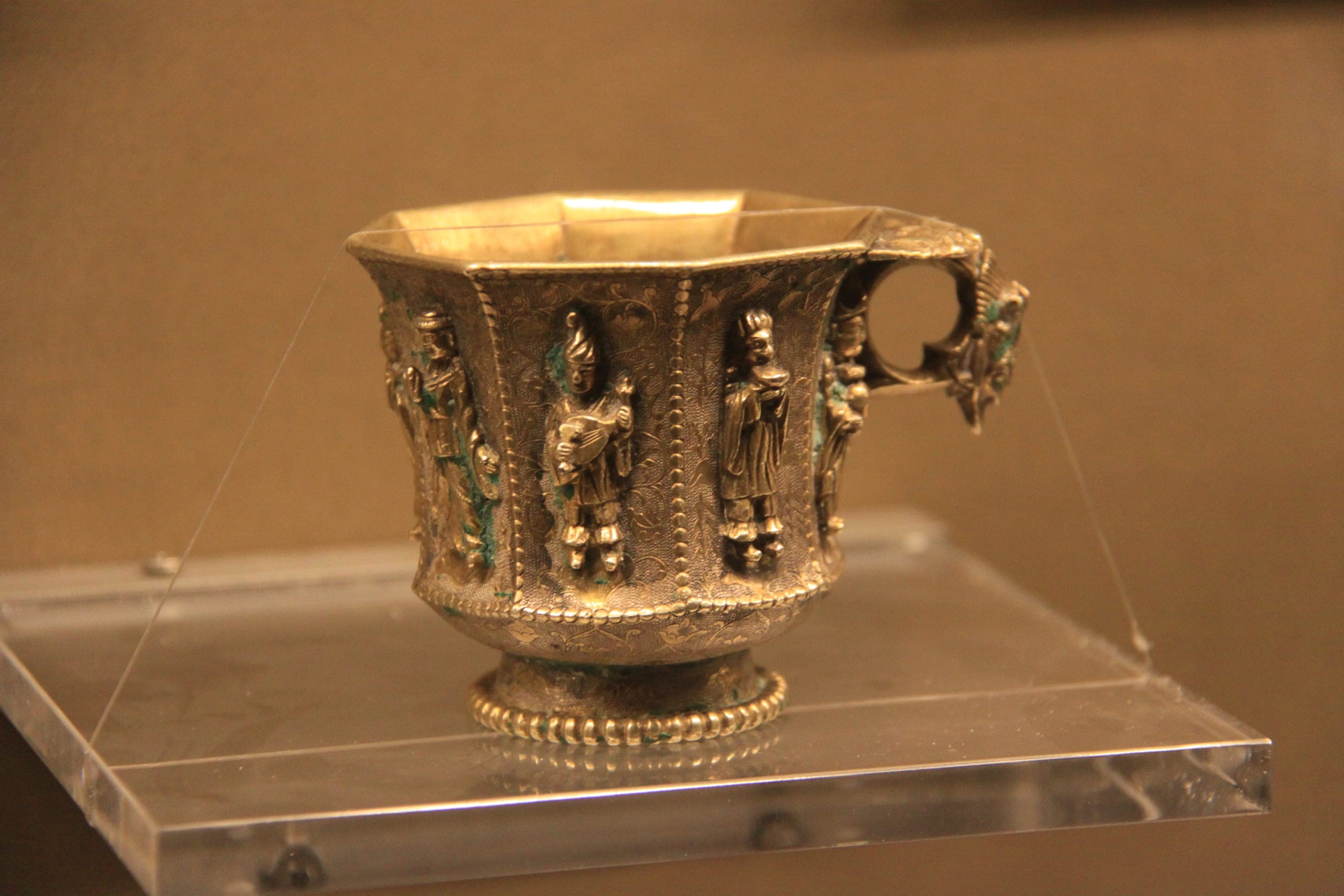 A Tang-dynasty gilded silver octagon cup with foreign musicians and dancers, from the Hejia Village hoard at the Shaanxi History Museum