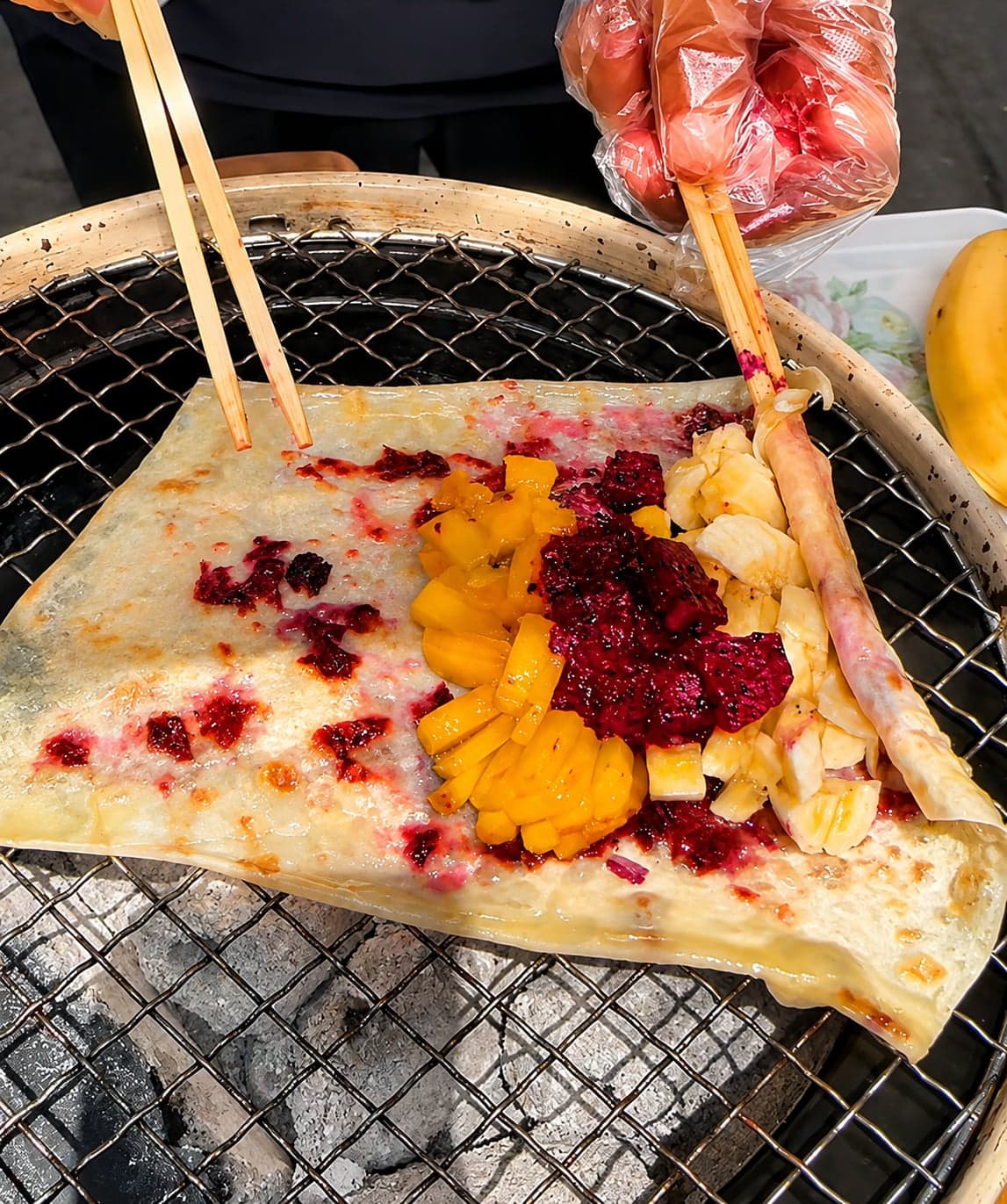 Yunnan rose-jam pastry rounds on a white plate, placeholder for Bai grilled rushan on a charcoal skewer with a rose-jam dip