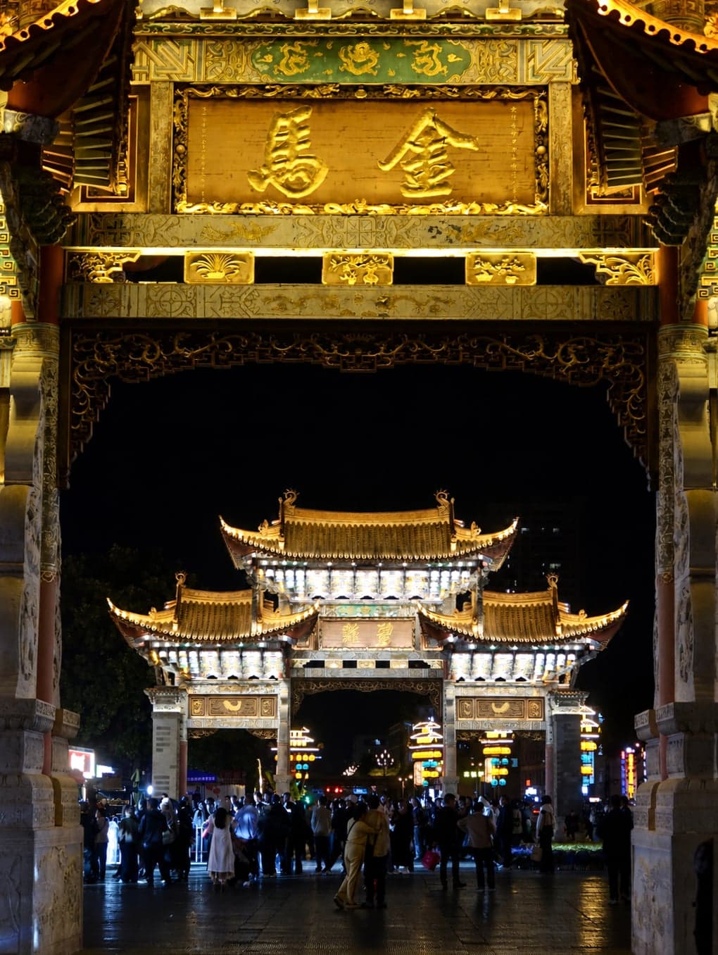 The twin Ming-style Jinma and Biji wooden archways at blue hour on Jinbi Road, Kunming