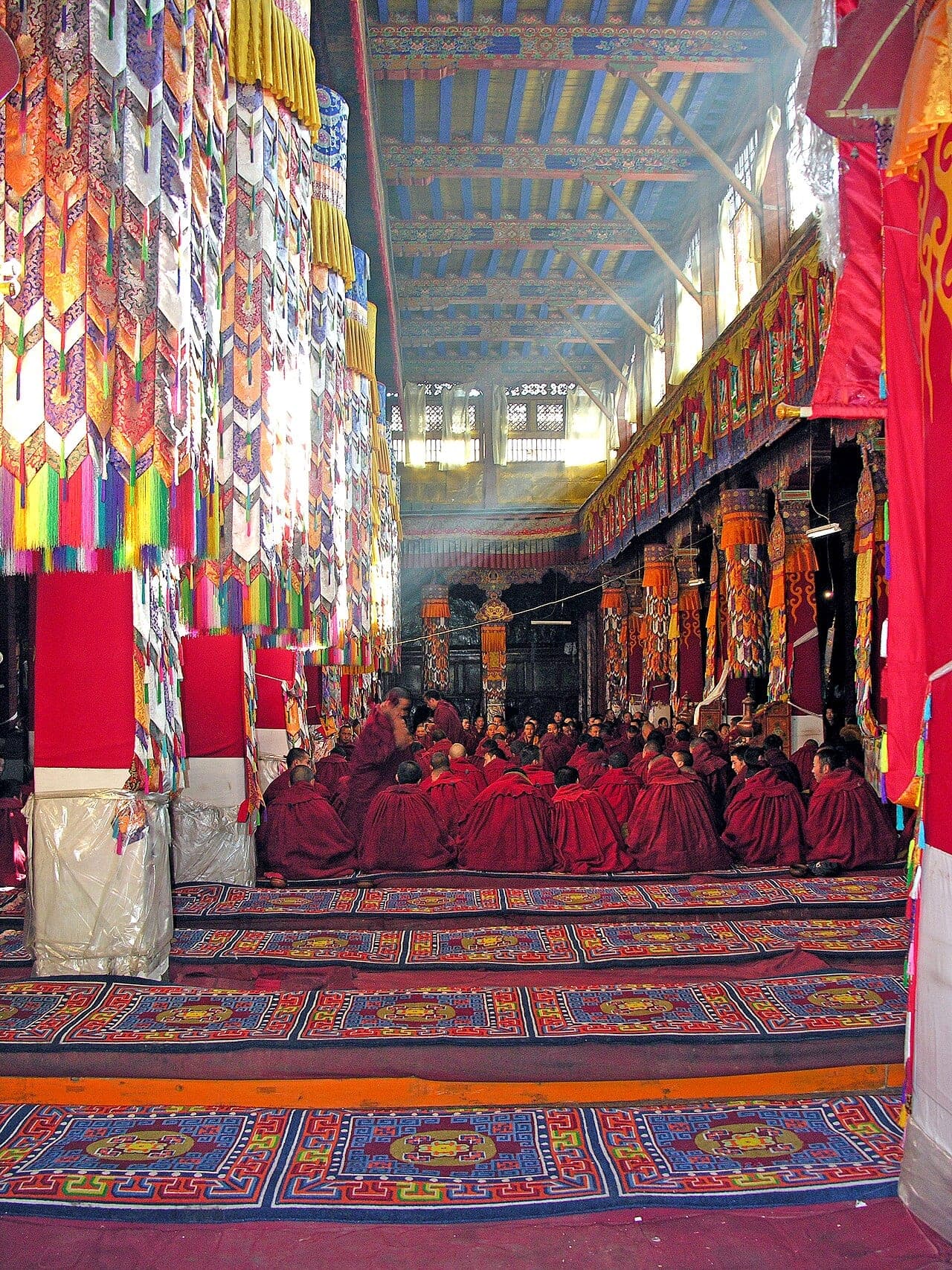 Monks in the great assembly hall at Drepung Monastery, Tibet
