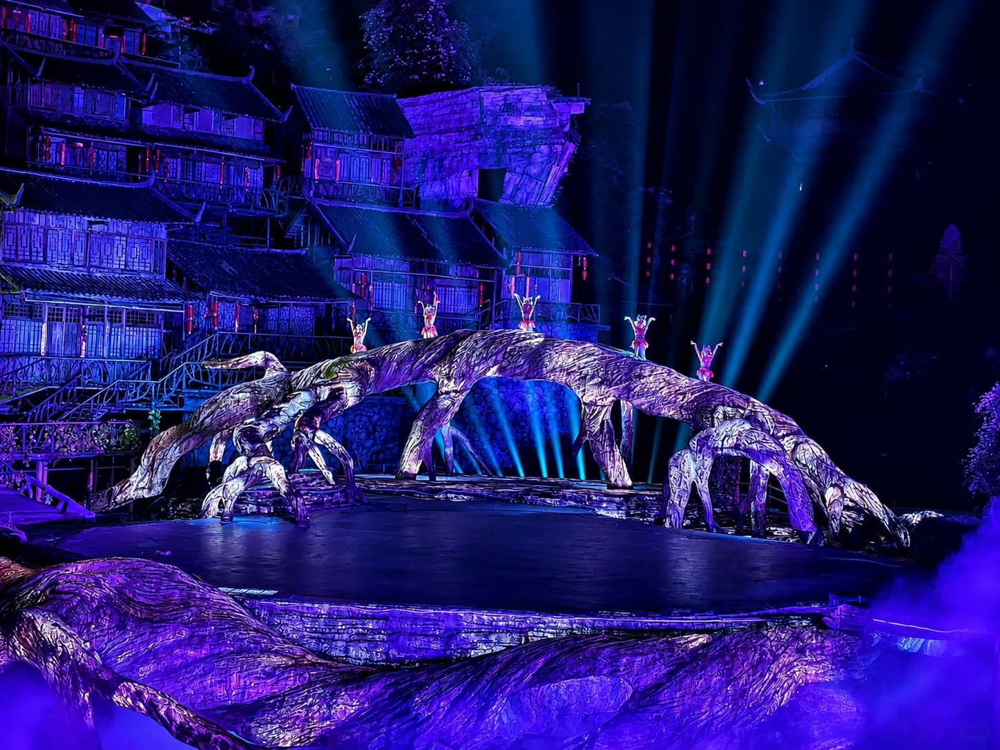 The Love of Fox Fairy outdoor show at the foot of Tianmen Mountain, the lit silhouette of the mountain rising behind the waterfall stage