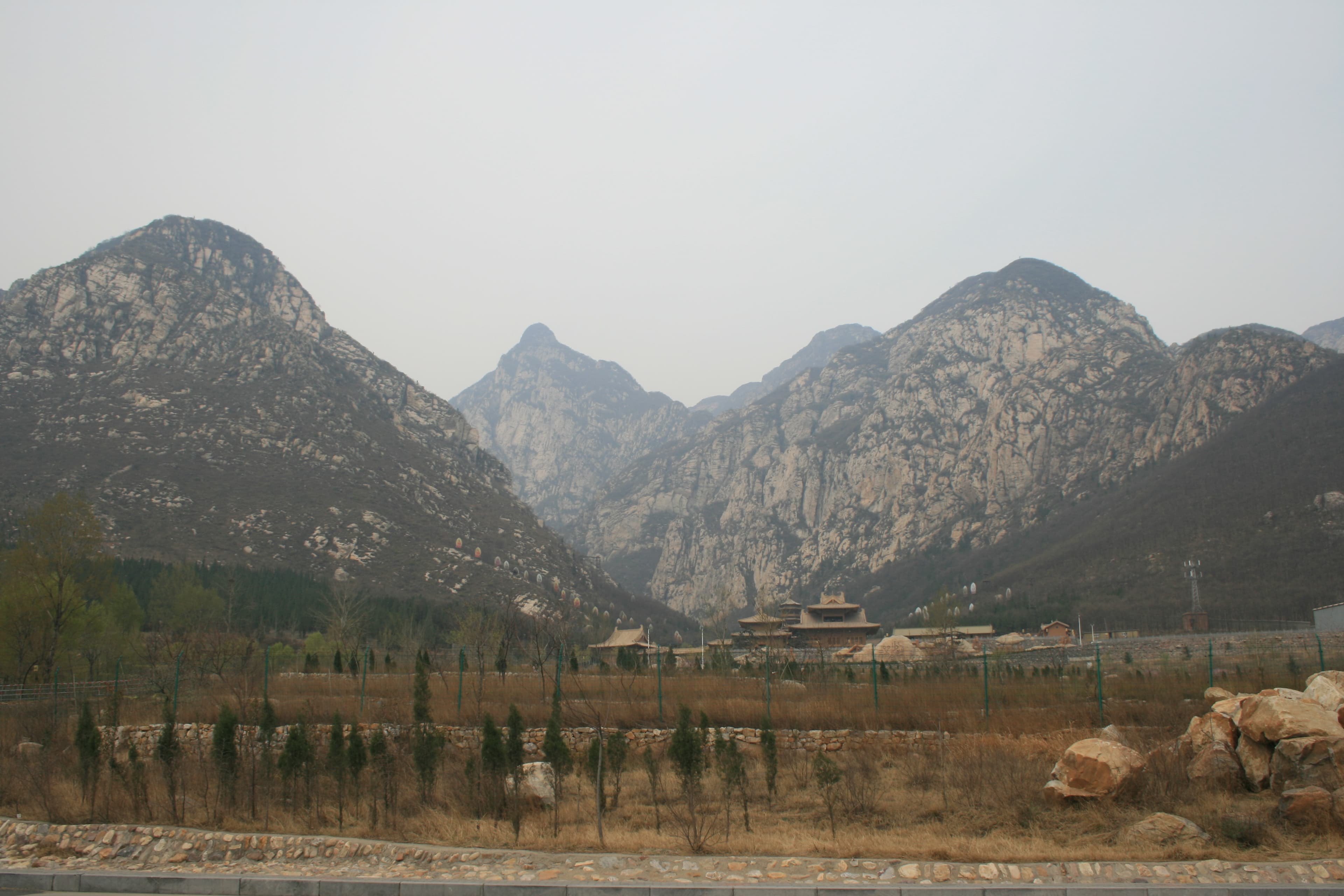 The forested ridges of Mount Songshan with stone steps climbing toward the Liantian summit, central peak of the five sacred mountains