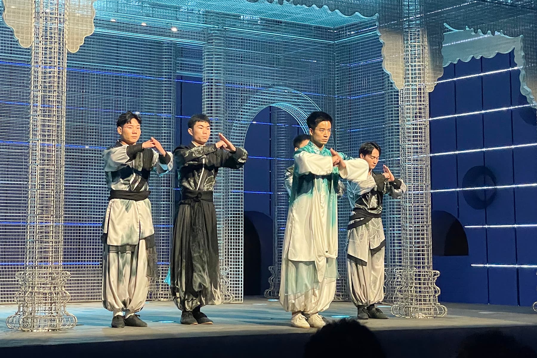 Performers in 1942 famine-era costume on a courtyard stage inside the walled Only Henan Drama Fortress in Zhengzhou, Wang Chaoge's 21-theatre immersive production